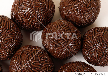 A serving of traditional Brazilian chocolate brigadeiros coated in sprinkles. A popular treat at parties and celebrations. A serving of traditional Brazilian chocolate brigadeiros coated in sprinkles. A popular treat at parties and celebrations. 142453974