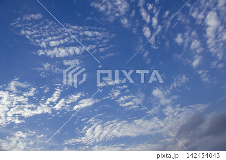 It is a blue sky with cirrocumulus clouds. It is a blue sky with cirrocumulus clouds. 142454043