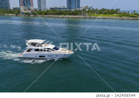 Motorboat sailing at sea. Luxury charter yacht in sea. Motor yacht luxury vessel. Sea motor boat. Sea summer vacation. Aerial motorboat. Yacht boat tour. Luxury boat yachting. Summer escape Motorboat sailing at sea. Luxury charter yacht in sea. Motor yacht luxury vessel. Sea motor boat. Sea summer vacation. Aerial motorboat. Yacht boat tour. Luxury boat yachting. Summer escape 142456544