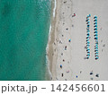 Sea relax under beach umbrella. Travel to sea. Aerial top view of sand beach with crystal clear turquoise water. Summer vacation in paradise. Beach vacation at sea in summer. Seychelles resort 142456601