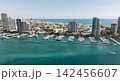 Yacht docked at Miami marina. Aerial view of coastline in Miami. Miami skyline above harbor. Famous Miami Beach marine from above. Marina with yachts. 142456607