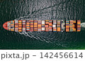 Shipping logistics. Commercial shipping. Top view. Cargo ship in sea, aerial view. Freight container loaded on cargo vessel. Aerial cargo ship with container. Cargo business. Container ship 142456614