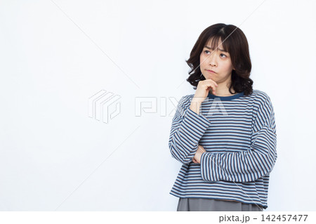 真剣に悩んでいる女性 142457477