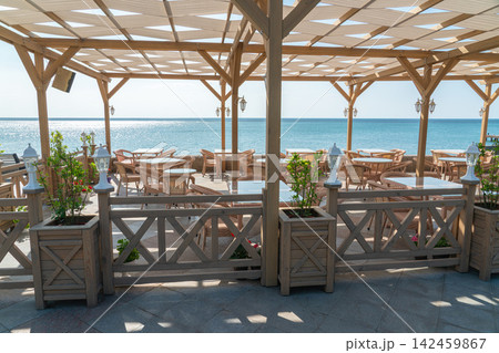 Outdoor seating area by the sea Outdoor seating area by the sea 142459867