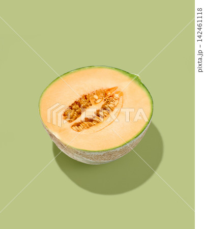 Half Cantaloupe Melon with Seeds Isolated on green Background Half Cantaloupe Melon with Seeds Isolated on green Background 142461118