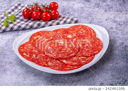 Sliced Spanish chorizo sausage on plate with fresh cherry tomatoes Sliced Spanish chorizo sausage on plate with fresh cherry tomatoes 142461306
