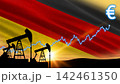 Mechanical oil pumps work beneath the waving national flag. Financial graph lines point to high market gains. 142461350