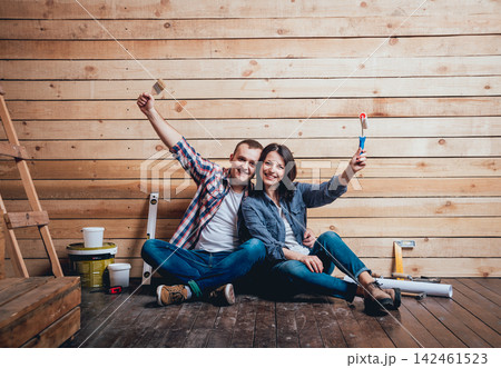 Happy couple making repairs to their home. Happy couple making repairs to their home. 142461523