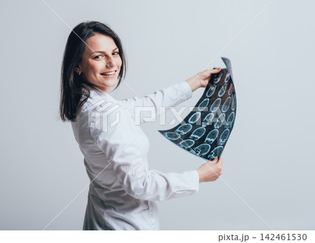 Doctor attentively examines the MRI scan of the patient. Doctor attentively examines the MRI scan of the patient. 142461530