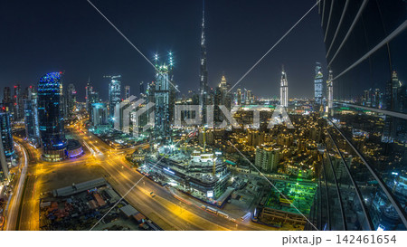 Dubai Downtown day to night timelapse. Aerial view over big futuristic city by night. Dubai Downtown day to night timelapse. Aerial view over big futuristic city by night. 142461654