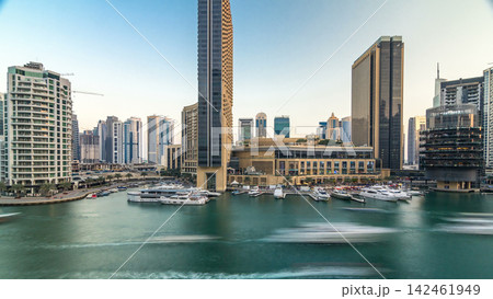 Aerial view of Dubai Marina with shopping mall, restaurants, towers and yachts timelapse, United Arab Emirates. Aerial view of Dubai Marina with shopping mall, restaurants, towers and yachts timelapse, United Arab Emirates. 142461949