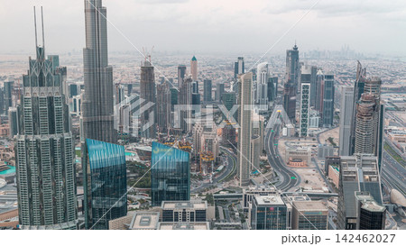 Dubai Downtown skyline futuristic cityscape with many skyscrapers and Burj Khalifa aerial night to day timelapse. Dubai Downtown skyline futuristic cityscape with many skyscrapers and Burj Khalifa aerial night to day timelapse. 142462027