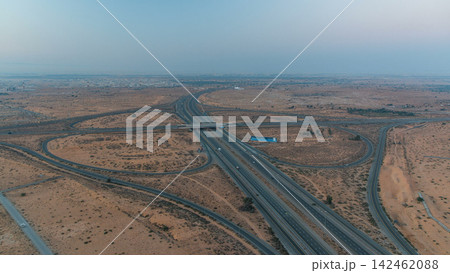 Highway roads with traffic night to day timelapse in a big city from Ajman to Dubai before sunrise. Highway roads with traffic night to day timelapse in a big city from Ajman to Dubai before sunrise. 142462088