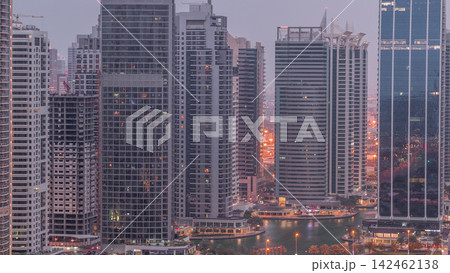 Residential and office buildings in Jumeirah lake towers district night to day timelapse in Dubai 142462138