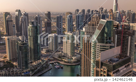Dubai Marina skyscrapers and jumeirah lake towers sunrise view from the top aerial timelapse in the United Arab Emirates. Dubai Marina skyscrapers and jumeirah lake towers sunrise view from the top aerial timelapse in the United Arab Emirates. 142462146