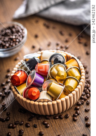 Colorful Coffee Pods And Espresso Capsules In A Decorative Bowl With Scattered Coffee Beans 142462192