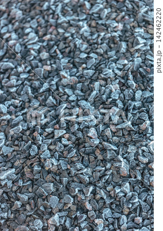 Small road stone with frozen background, dark gravel pebbles stone texture seamless texture, blurred scene with selective focus, shallow depth of the field 142462220