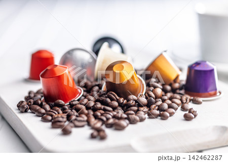 Colorful Coffee Capsules on Roasted Coffee Beans for Espresso and Capsule Brewing Colorful Coffee Capsules on Roasted Coffee Beans for Espresso and Capsule Brewing 142462287