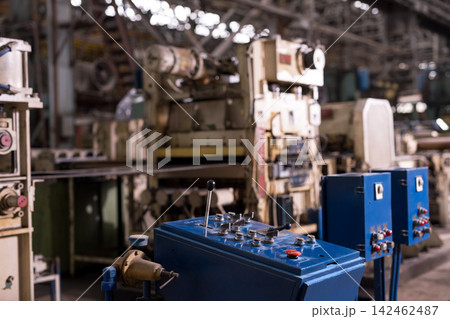 Industrial factory control panel with machinery in background Industrial factory control panel with machinery in background 142462487