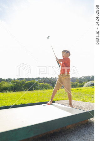 Young boy learning golf on sunny summer day Young boy learning golf on sunny summer day 142462969