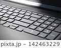 Close up of a modern laptop keyboard with focus on keys, remote work, technology and computer use concept, macro photo 142463229