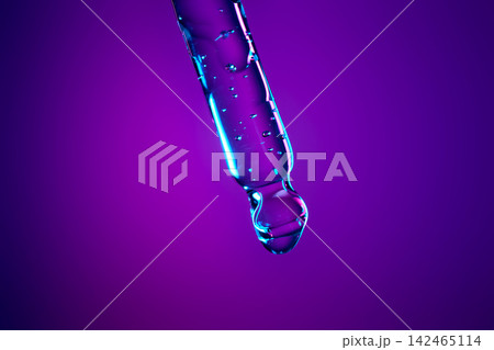 Serum drop dripping from pipette creating bubbles in liquid Serum drop dripping from pipette creating bubbles in liquid 142465114