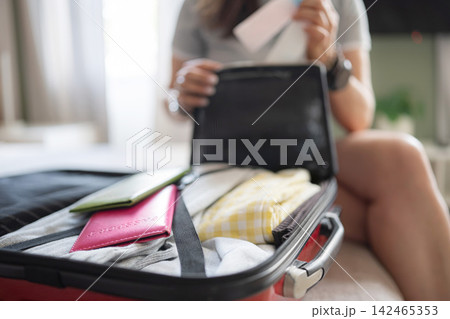 Girl Packing Liquid Containers In Luggage Checking Volume To Meet 100 Ml Hand Luggage Limit 142465353