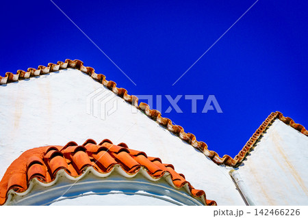 Greek church roof tiles against blue sky Crete Greece Greek church roof tiles against blue sky Crete Greece 142466226
