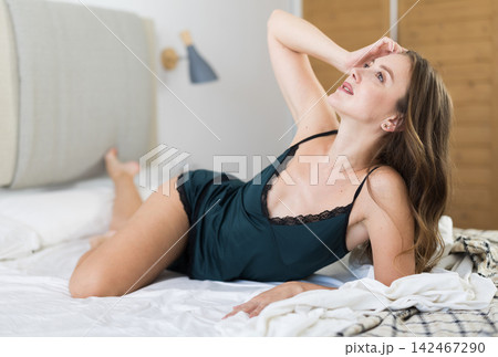 Woman posing in bedroom in home clothes Woman posing in bedroom in home clothes 142467290