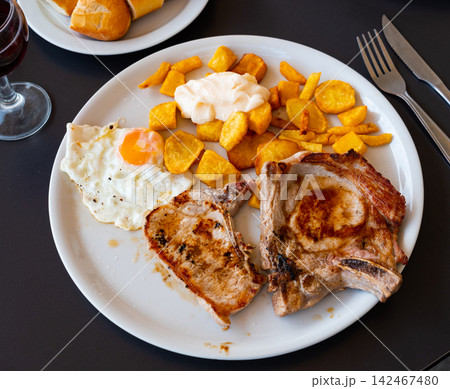 Pork chop served with potatoes and egg Pork chop served with potatoes and egg 142467480