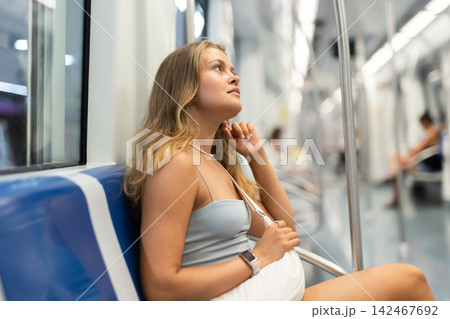 Young girl sitting in wagon travelling by subway 142467692