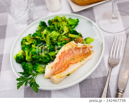 Appetising roasted rockfish fillet with seared broccoli Appetising roasted rockfish fillet with seared broccoli 142467736