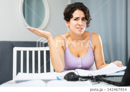 Young girl manager has problems and stress during work at laptop Young girl manager has problems and stress during work at laptop 142467954