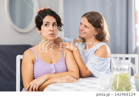 Woman comforting her friend after domestic quarrel Woman comforting her friend after domestic quarrel 142468124