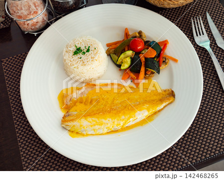 Sea bass with curry, vegetables and rice Sea bass with curry, vegetables and rice 142468265