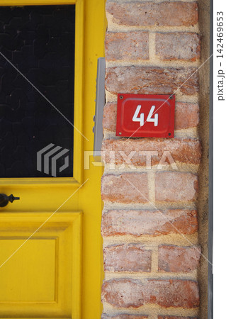 Number on a brick wall by the door Number on a brick wall by the door 142469653