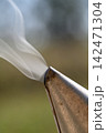 Macro smoke curling from bee smoker nozzle Macro smoke curling from bee smoker nozzle 142471304