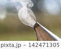 Swirling smoke rising from bee smoker spout Swirling smoke rising from bee smoker spout 142471305