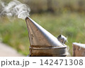 Weathered bee smoker cone releasing smoke outdoors Weathered bee smoker cone releasing smoke outdoors 142471308