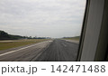 View along an airport runway from an aircraft window during take-off 142471488