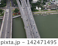 Aerial view of a multi-lane elevated highway bridge over water 142471495