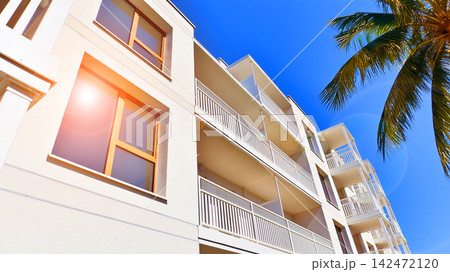 European residential architecture harmonizing with nature. Eco-friendly living in city with greens. Eco apartment building saving energy and fresh air concept. European residential architecture harmonizing with nature. Eco-friendly living in city with greens. Eco apartment building saving energy and fresh air concept. 142472120