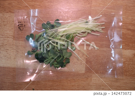 Fresh Sprouts in Plastic Bag on Wooden Surface Fresh Sprouts in Plastic Bag on Wooden Surface 142473072