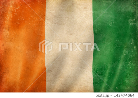 Old vintage flag of Ivory Coast, worn and stained Old vintage flag of Ivory Coast, worn and stained 142474064