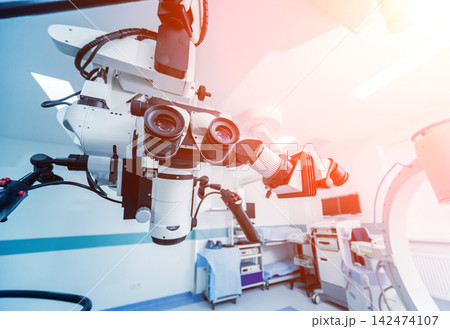Modern microscope for operations in surgery room at the hospital. Modern microscope for operations in surgery room at the hospital. 142474107