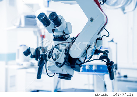 Modern microscope for operations in surgery room at the hospital. Modern microscope for operations in surgery room at the hospital. 142474118