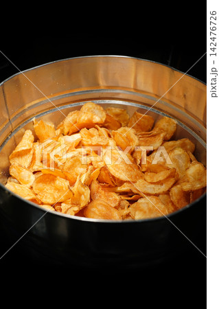 Crispy and Golden Homemade Potato Chips Served in a Metal Basket Crispy and Golden Homemade Potato Chips Served in a Metal Basket 142476726