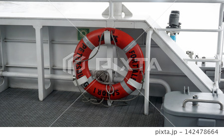 Lifebuoy on a ship's railing. Lifebuoy on a ship's railing. 142478664