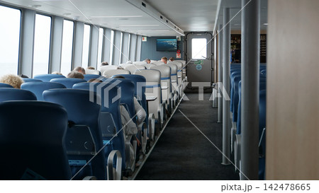 Passengers on seats inside the sea vessel Meteor Passengers on seats inside the sea vessel Meteor 142478665