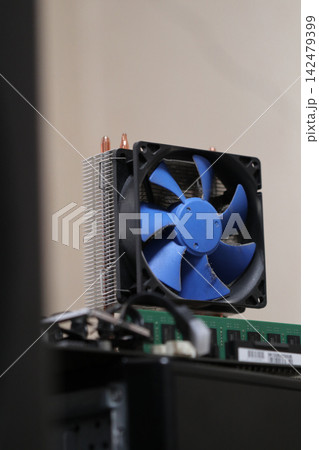 Cooler and components on a computer setup in a workspace. Cooler and components on a computer setup in a workspace. 142479399